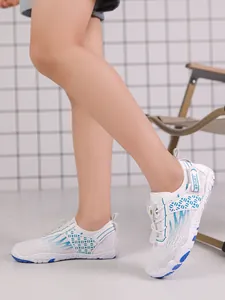 Side view of child wearing breathable white and blue mesh water shoes for beach activities