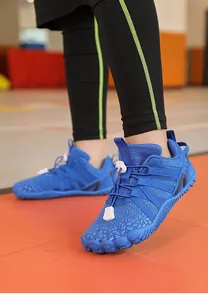 Detailed view of blue children's five-finger minimalist sports shoes on gym flooring