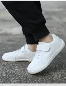 Detailed side view of white children's breathable casual sneakers with velcro straps