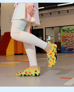 Yellow kids' quick-dry aqua shoes with vibrant starfish and seashell patterns