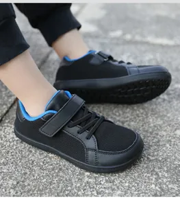 Close-up of children's black flyknit sneakers with blue lining and velcro strap