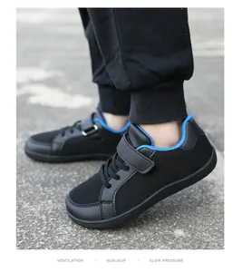 Detailed side view of black kids fly-knit sneakers with blue trim and velcro strap closure.