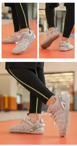 Detailed macro view of kids' minimalist barefoot gym shoes in grey during indoor exercise