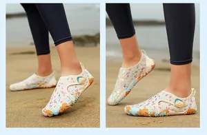 Close-up of colorful barefoot water shoes on sand with anti-slip soles for beach sports.