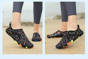 Close-up view of the colorful graffiti pattern and anti-slip rubber soles on quick-dry water shoes