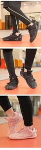 Close-up detail of kids' indoor non-slip sports shoes with five-finger sole design.