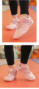 Close-up of pink children's non-slip fitness shoes with five-finger soft-sole design.