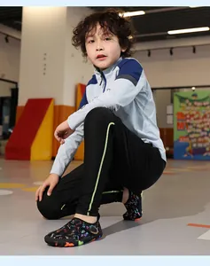 Close-up view of a child wearing non-slip quick-dry barefoot aqua shoes in an indoor gym setting