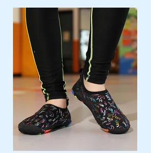 Detailed view of black barefoot water shoes with colorful graffiti print