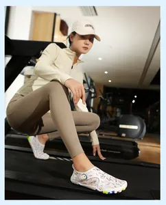 Detailed view of white patterned barefoot water shoes on a gym treadmill