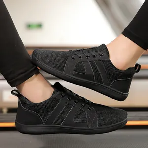 Professional black barefoot training shoes with wide toe box shown on feet in gym