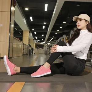 Woman wearing pink wide-toe box barefoot shoes for cross-training in a gym environment