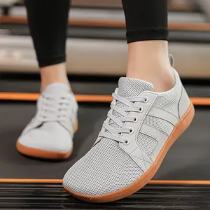 Detailed close-up of grey mesh wide-toe barefoot training shoe with durable gum sole