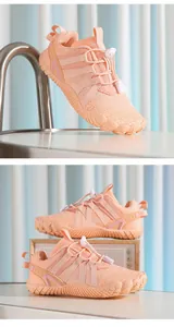 Detailed view of pink breathable kids' five-finger sports shoes with quick-lace system