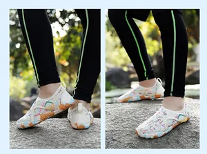 Side view of quick-dry water shoes with colorful graffiti on rocky outdoor terrain