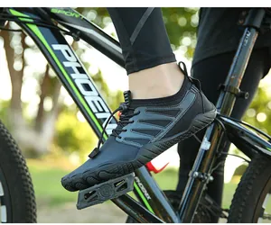 Close-up of black breathable barefoot water shoe on a bicycle pedal for outdoor use