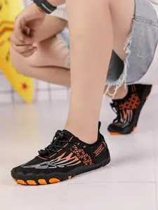 Detailed close-up of children's black and orange anti-slip water shoes for swimming