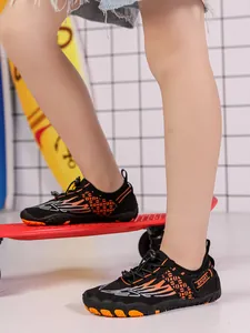 Close-up of children's non-slip water shoes with orange wing pattern and SPORT logo
