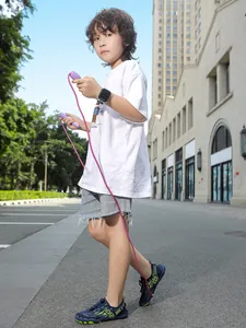 Young boy wearing non-slip children's water shoes for wading and outdoor play
