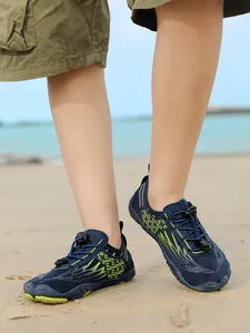 Close-up shot of durable non-slip children's water shoes being worn on a sandy beach