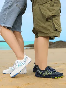 Close-up details of children's anti-slip water shoes worn on a sunny sandy beach.