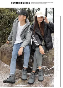 Models wearing warm grey outdoor snow boots with thick soles in a natural winter setting