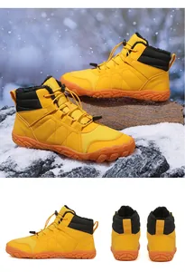 High-top yellow winter snow boots with plush lining and non-slip soles shown in snow