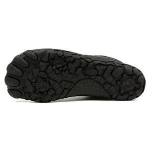 Detailed view of non-slip rubber sole on black five-finger barefoot outdoor boots