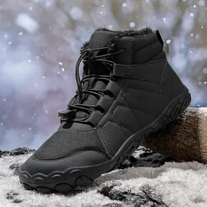 Detailed view of black barefoot snow boots with warm plush lining and toggle lacing