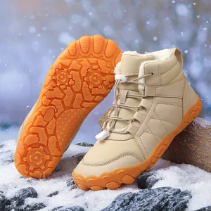 Detailed view of waterproof five-toe snow boots with thick fur lining and orange sole.