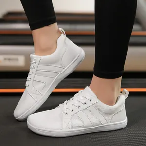Close-up view of white wide-toe barefoot training shoes for professional fitness and running