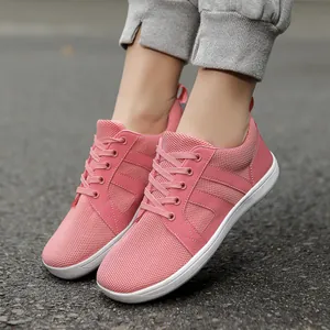 Detailed view of pink wide-toe box barefoot shoes with breathable mesh and white sole