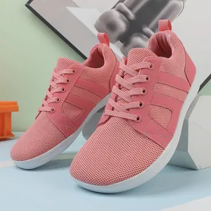 Detailed macro view of pink breathable barefoot running shoes for gym training sessions.
