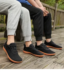 Outdoor lifestyle view showing breathable black barefoot shoes with flexible orange rubber sole
