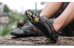 Close-up of quick-dry wading shoe sole with colorful camouflage pattern on a rock