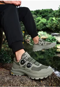 Close-up view of olive green outdoor hiking shoes featuring a durable dual knob lacing system.