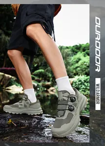 Detailed view of waterproof hiking cycling shoes with BOA dial system on rocky terrain