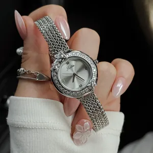 Detailed macro view of Scottie silver mesh watch featuring a floral rhinestone bezel