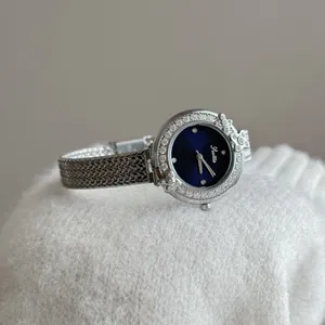 Close-up of Scottie 9870 silver watch with blue dial and diamond garland bezel