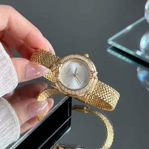 Close-up of Scottie luxury quartz watch with diamond wreath bezel and gold mesh strap