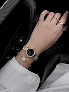 Detail shot of the gold Scottie watch with marble dial and crystal bezel on wrist.