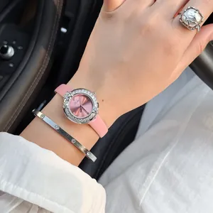 Close-up of Scottie luxury pink dial watch with rhinestone floral wreath and pink strap
