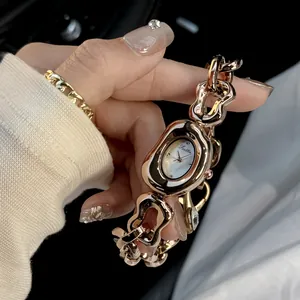 Detailed view of Scottie rose gold quartz watch featuring irregular hollow chain strap