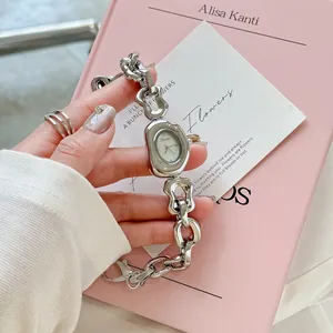 Close-up of Scottie irregular hollow silver chain watch with an organic dial design.