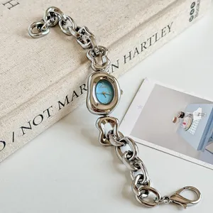 Detail view of Scottie 9736 irregular chain watch with a vintage aesthetic background.