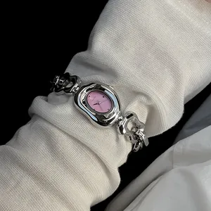 Close-up of women's fashion quartz watch with irregular silver case and chain strap