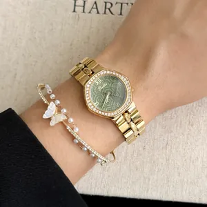 Close-up of Scottie gold-tone watch with green honeycomb dial and crystal bezel on wrist
