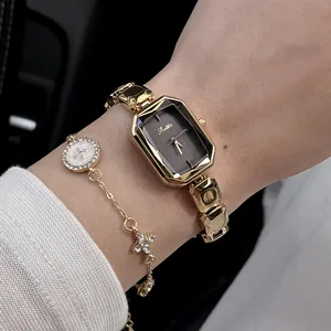 Close-up of a Scottie gold-toned women's quartz watch with a diamond-studded bracelet