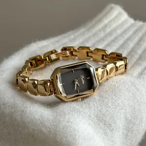 Close-up of Scottie gold women's quartz watch with black octagonal dial on white knit