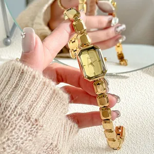 Close-up of Scottie gold women watch with unique faceted rectangular dial and link bracelet